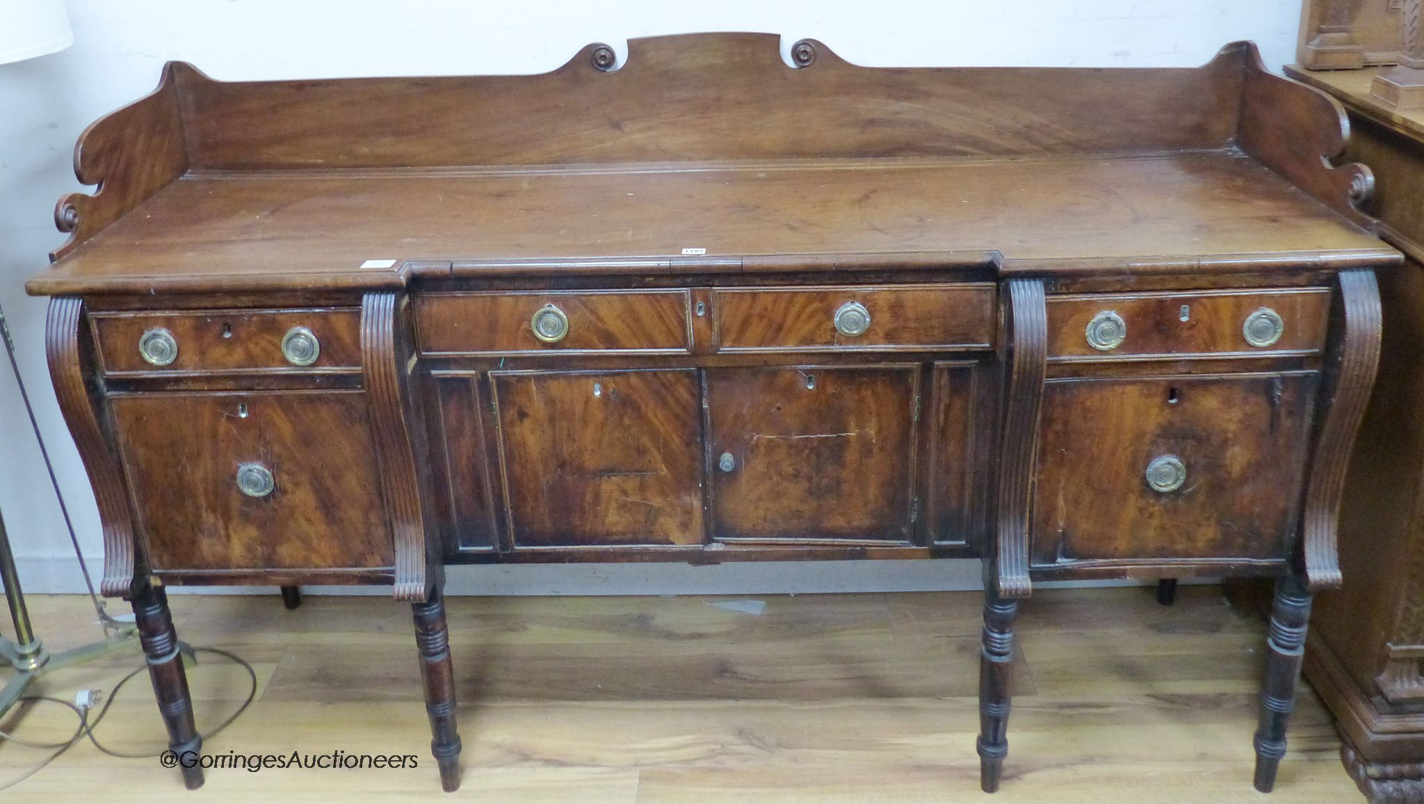 A Regency mahogany inverse breakfront sideboard. W-184, D-60, H-108cm.